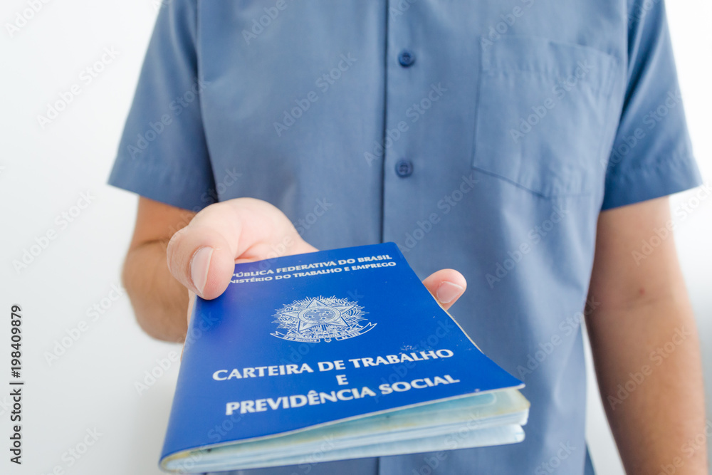 Unemployed worker from Brazil show his work permit document (carteira de trabalho in portuguese) while looking for a job